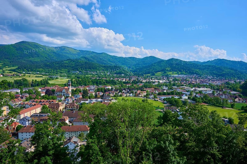 View of a district town surrounded by green hills under a cloudy blue sky, Waldkirch, Breisgau, Black Forest, Baden-Württemberg, Germany