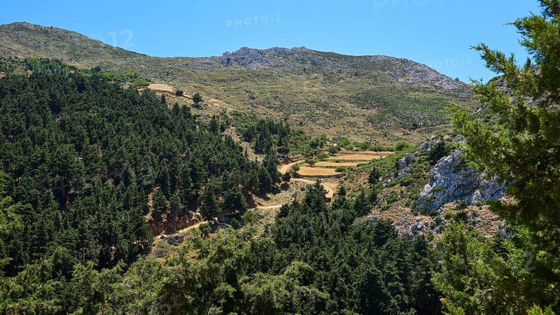 A wide view over wooded mountain slopes and valleys under a blue sky, Abandoned Village, Lost Place, Pyli, Paleo Pyli, Byzantine Fortress, Kos, Dodecanese, Greek Islands, Greece