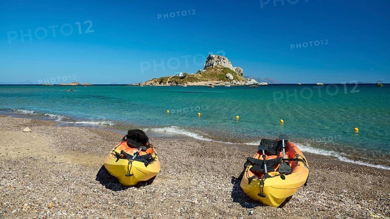 Two kayaks on the beach with a view of a small island in the blue sea, Agios Stefanos Beach, Agios Stefanos Basilica, Chapel of Agios Nikolaos, Kastri Island, Kos, Dodecanese, Greek Islands, Greece