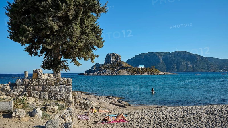 Summer beach view with view of a small island and chapel, Agios Stefanos Beach, Agios Stefanos Basilica, Chapel Agios Nikolaos, Kastri Island, Kos, Dodecanese, Greek Islands, Greece