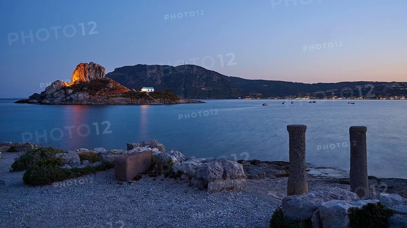 Night view of an island with illuminated rock and a small chapel in the calm water, Agios Stefanos Beach, Agios Stefanos Basilica, Chapel Agios Nikolaos, Kastri Island, Kos, Dodecanese, Greek Islands, Greece