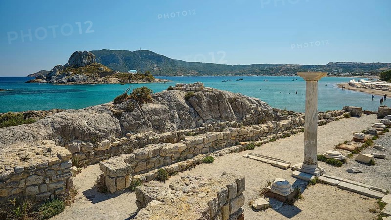 Ruins with a view of an island in the background, bright blue sea, Agios Stefanos Beach, Agios Stefanos Basilica, Agios Nikolaos Chapel, Kastri Island, Kos, Dodecanese, Greek Islands, Greece