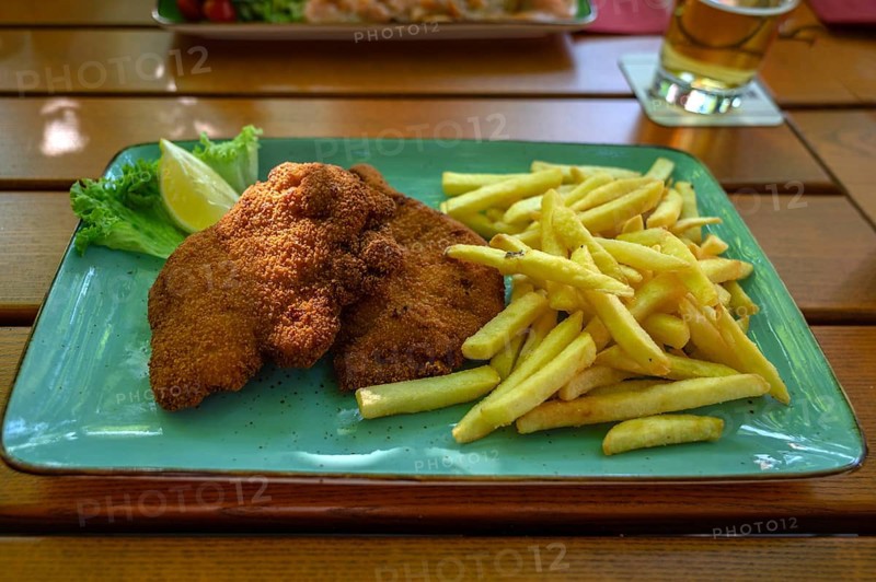 Wiener Backhändel with French fries, served in a garden restaurant, Franconia, Bavaria, Germany