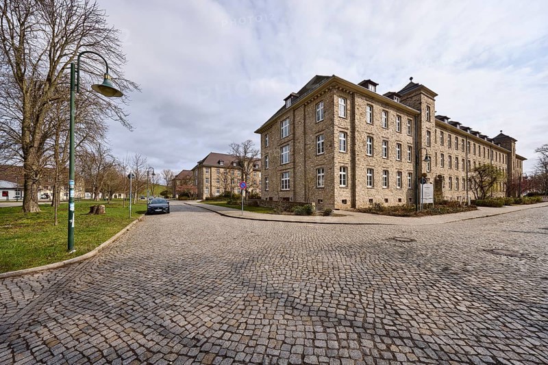 Tax office, sandstone building, bare wintry trees, lantern, diffuse light, slightly sunny, milky blue cloudy sky, street Tessenowstraße, Magdeburg, state capital, independent city, Saxony-Anhalt, Germany