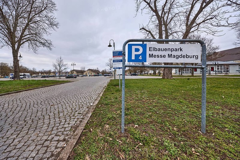 Car park, Elbauenpark, Magdeburg Trade Fair, cobblestone street, bare winter trees, lawn, lantern, diffuse light, cloudy, Tessenowstraße, Magdeburg, state capital, independent city, Saxony-Anhalt, Germany