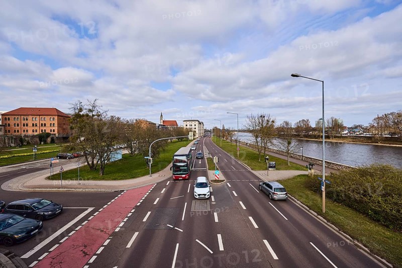 River Elbe, streets, traffic lights, lane markings, lanes, vehicles, cars, coach, bare wintry trees, lanterns, lawn, bird's eye view, diffuse light, blue sky, cumulus clouds, intersection Schleinufer with Gouvernementsberg and Fürstenwallstraße, Magdeburg, state capital, independent city, Saxony-Anhalt, Germany