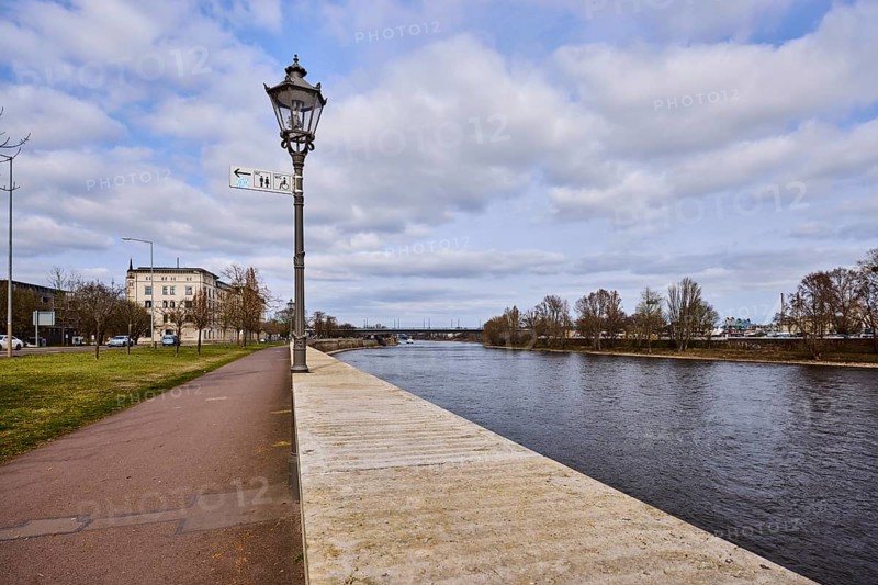 River Elbe, riverside promenade, lantern, sandstone wall, bare wintry trees, general architecture, diffuse light, blue sky, cumulus clouds, banks of the river Schlein, Magdeburg, state capital, independent city, Saxony-Anhalt, Germany