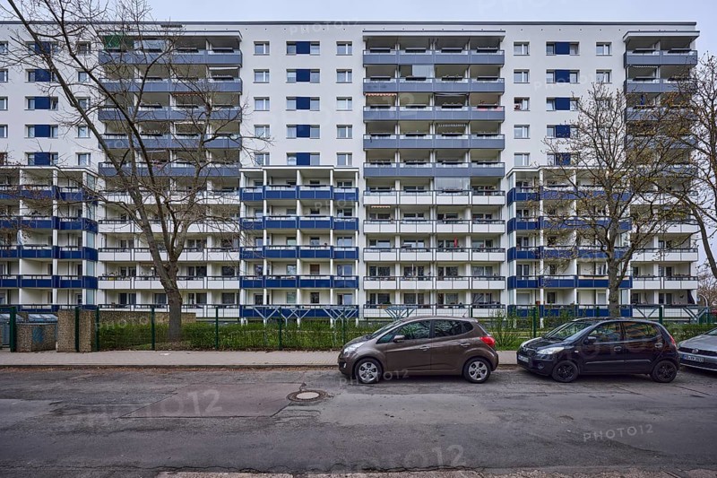 High-rise buildings, residential buildings, residential silos, facade, window, balcony, car park with vehicles, bare winter trees, diffuse light, cloudy, Victor-Jara-Straße, Magdeburg, state capital, independent city, Saxony-Anhalt, Germany