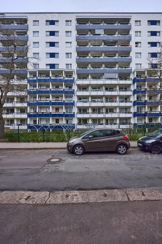 High-rise buildings, residential buildings, residential silos, facade, window, balcony, car park with vehicles, bare winter trees, diffuse light, cloudy, Victor-Jara-Straße, Magdeburg, state capital, independent city, Saxony-Anhalt, Germany