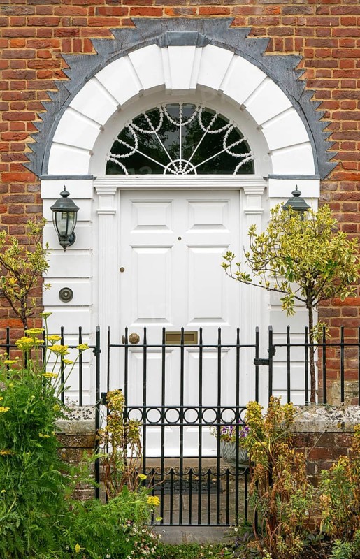 Historic Georgian style house door arched doorway with fanlight, Salisbury, Wiltshire, England, UK
