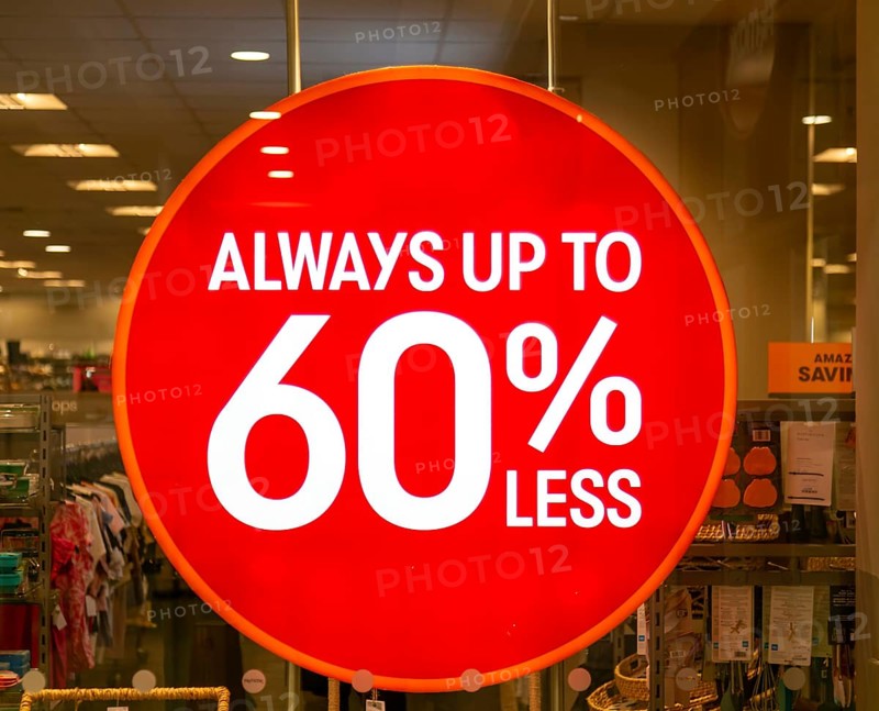 Always up to 60% less sale sign in TK Maxx shop window, Wiltshire, England, UK