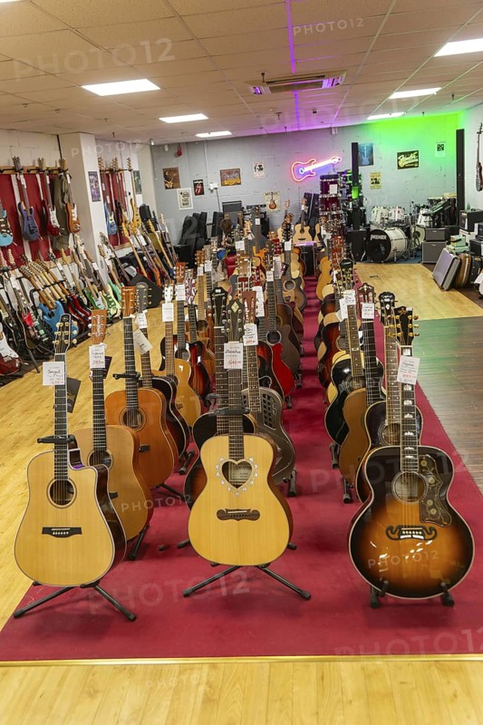 Guitars on display inside shop Sarum Guitars & Drums, Salisbury, Wiltshire, England, UK