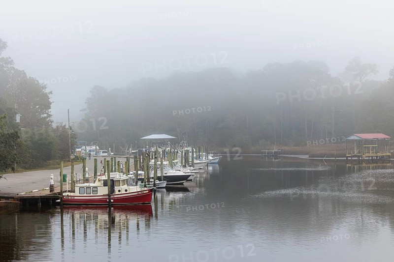 Private fishing boats in the harbor at Ocean Springs, Mississippi on a foggy morning