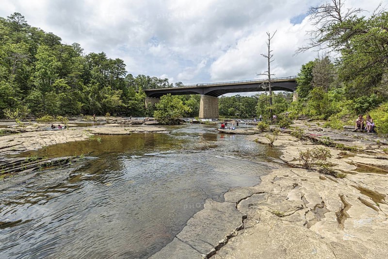 People playing on the rocks under the Little River Falls Bridge in Little River Canyon Falls Park near Ft. Payne, Alabama