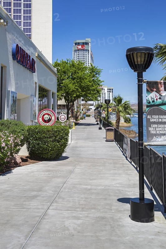 Sidewalk runs along the Colorado River behind casinos and restaurants in Laughlin, Nevada