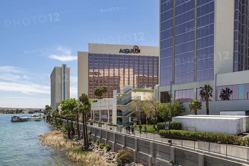 Sidewalk runs along the Colorado River behind casinos and restaurants in Laughlin, Nevada