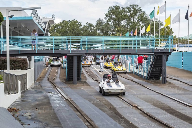 Black man and son riding a car in the Tomorrowland Speedway at the Tomorrow land area of the Magic Kingdom at Walt Disney World, Orlando, Florida