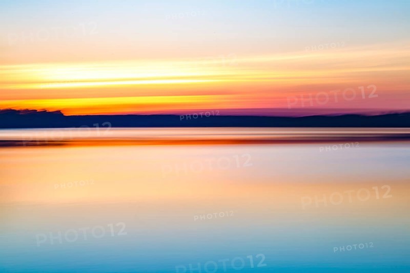 Motion blurred abstract lake at sunset background or wallpaper