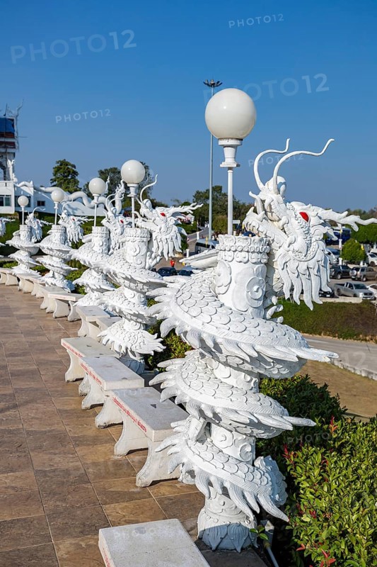 Ornate dragon sculptures around the perimeter of the Guan Yin (Goddess of Mercy) statue at Wat Huay Pla Kang Temple in Chiang Rai province of Northern Thailand