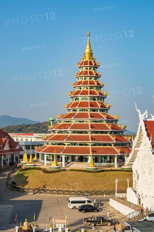 Nine tiered pagoda with gold dragons on each rooftop at Wat Huay Pla Kang in Chiang Rai, Thailand