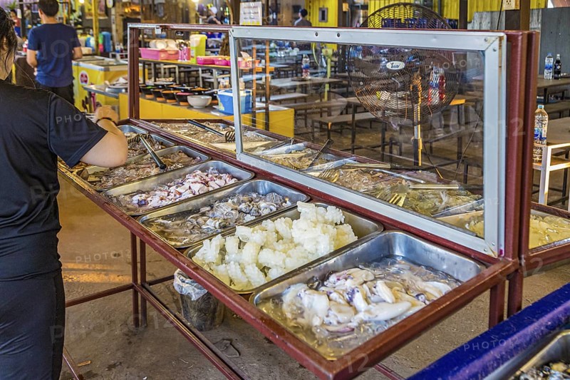 Selection of raw seafood available for customers at a buffet style outdoor restaurant in Chiang Rai province of Northern Thailand