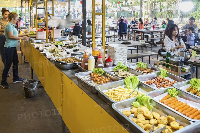 Selection of prepared foods available for customers at a buffet style outdoor restaurant in Chiang Rai province of Northern Thailand