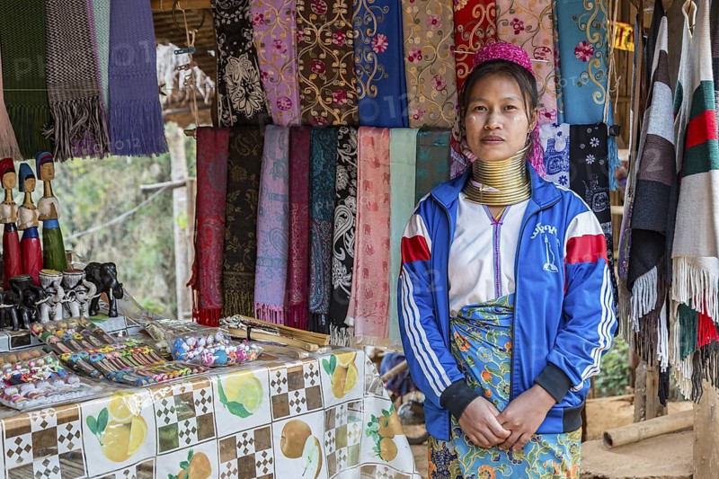 Tribal woman selling woven scarves and other crafts in the Long Neck Karen tribe (more properly called the Kayah Lahwi tribe) area of the Union of Hill Tribe Villages outside of Chiang Rai in the Nanglae District of Thailand