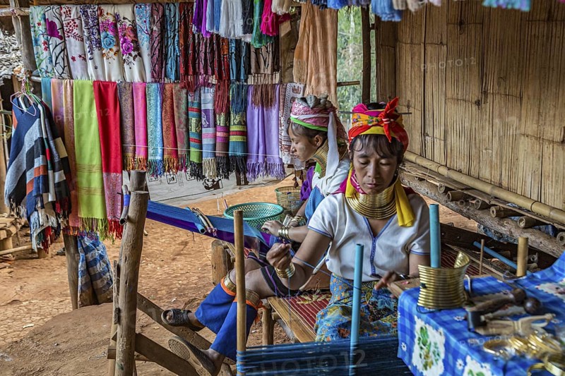 Tribal women weaving scarves to be sold in the Long Neck Karen tribe (more properly called the Kayah Lahwi tribe) area of the Union of Hill Tribe Villages outside of Chiang Rai in the Nanglae District of Thailand