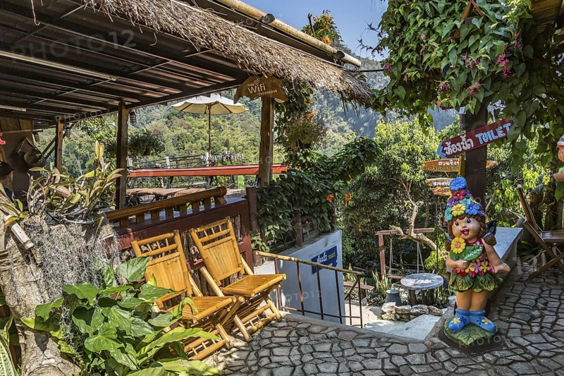 Signs and gardens at the Doi Phamee coffee shop and restaurant in Mae Sai district of Chiang Rai, Thailand