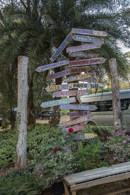 Sign post with arrows pointing to other places and showing the distance from Chiang Rai, Thailand