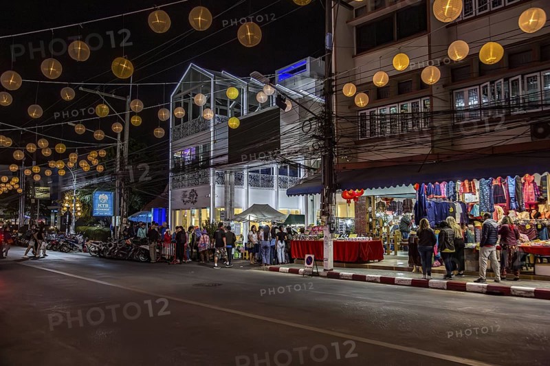 Tourists and locals entering the Night Market in downtown Chiang Rai, Thailand