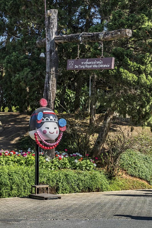 Sign points to the entrance tot he Doi Tung Royal Villa inside the Doi Tung tourist attraction in Chiang Rai, Thailand