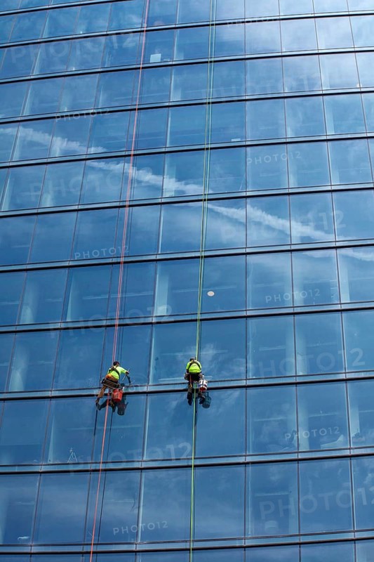 Detroit, Michigan - Window washers at the 25-story Residences Water Square luxury apartment building