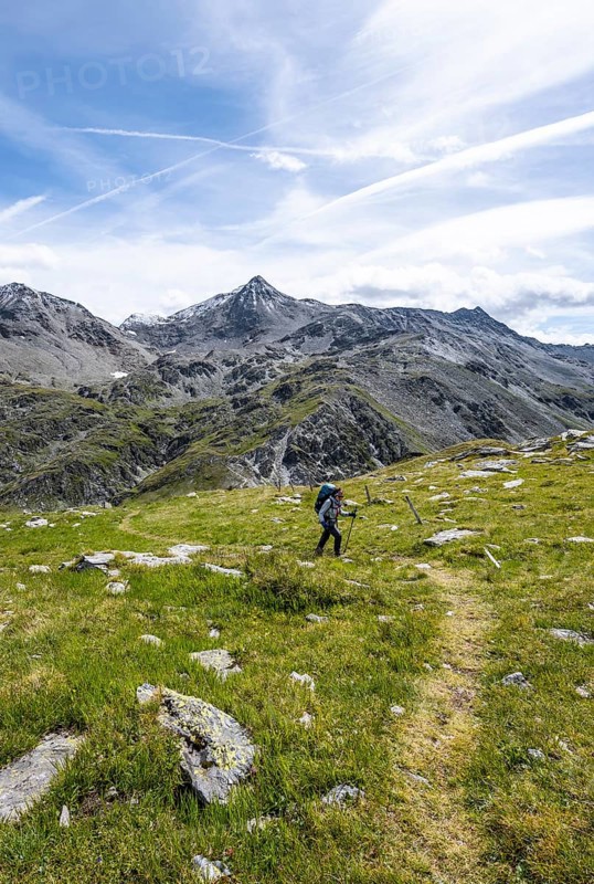 Mountaineer on hiking trail above the Peischachtörl, summit Böses Weibl in the background, Wiener Höhenweg, Schober group, Hohe Tauern National Park, Carinthia, Austria