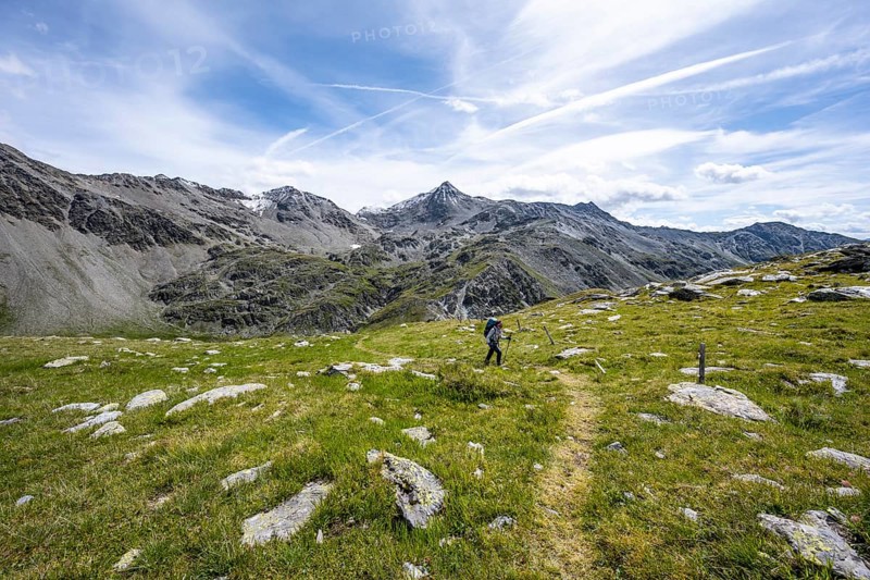 Mountaineer on hiking trail above the Peischachtörl, summit Böses Weibl in the background, Wiener Höhenweg, Schober group, Hohe Tauern National Park, Carinthia, Austria