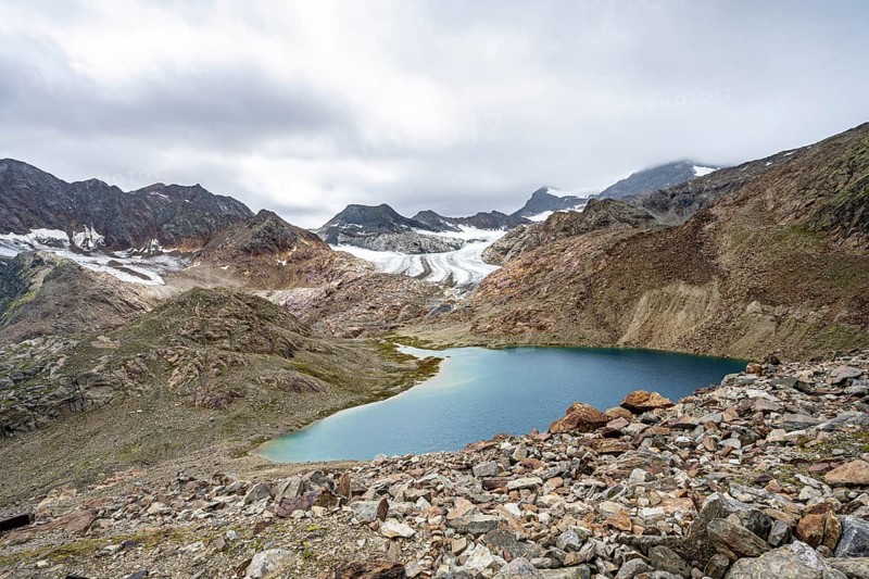 Mountain lake Vogelhüttensee, high mountain landscape with glacier Übeltalferner in the background, Stubai Alps, South Tyrol, Italy