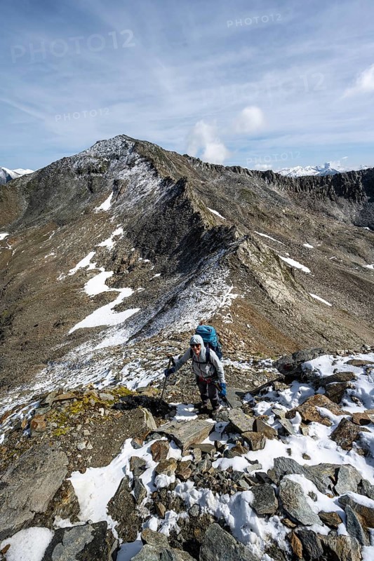 Mountaineer climbing in high mountain landscape at the Kesselkeessattel to the Bösen Weibl, Wiener Höhenweg, Schober group, Hohe Tauern National Park, Carinthia, Austria