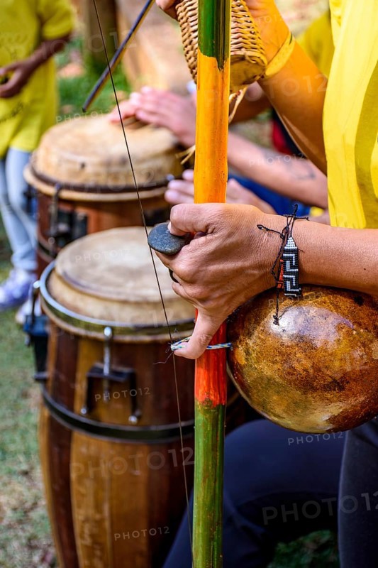 Meeting of Brazilian musicians playing their berimbaus and atabaques outdoors, Minas Gerais, Brazil