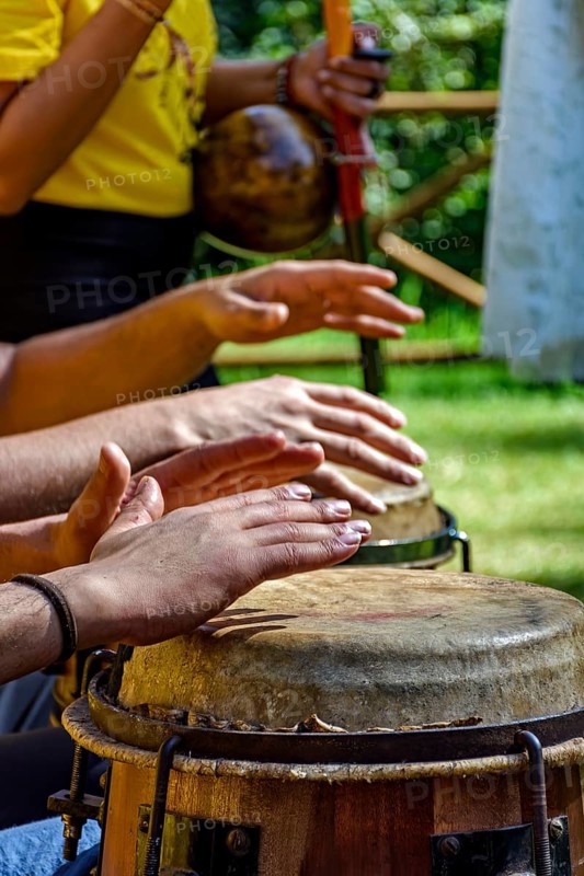 Musicians playing berimbau and atabaque in Brazilian capoeira outdoors, Minas Gerais, Brazil