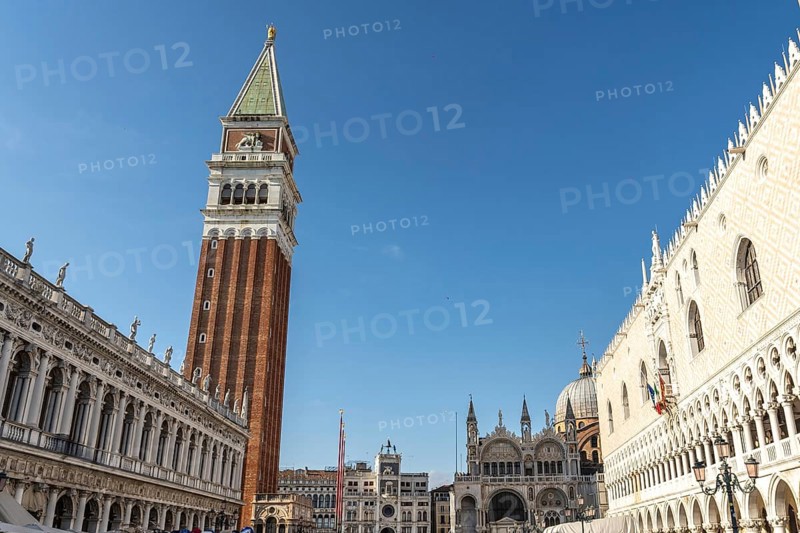 Scenic view of piazza san marco with its famous landmarks, including st. Mark's campanile and doge's palace, under a clear blue sky