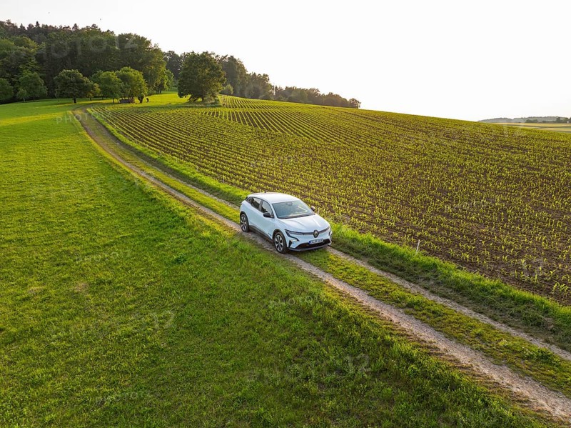 Vehicle travelling along a green country road through wide fields, Renault Megane, Deer E Carsharing, electric car, Calw, Black Forest, Germany