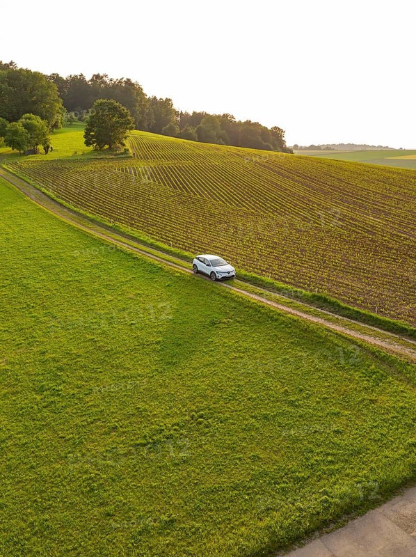 Car driving along a green country road through a quiet, rural landscape, Renault Megane, Deer E Carsharing, electric car, Calw, Black Forest, Germany