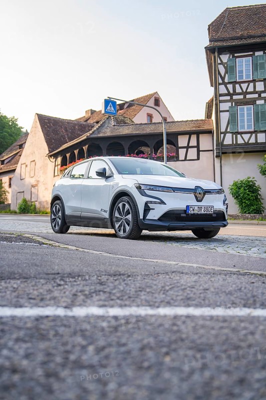 Modern car on an urban street, surrounded by historic half-timbered houses in the warm evening light, Renault Megane, Deer E Carsharing, electric car, Calw, Black Forest, Germany