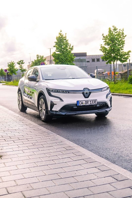 White electric car from Renault parked on a city street under a cloudy sky, Renault Megane, Deer E Carsharing, electric car, Calw, Black Forest, Germany