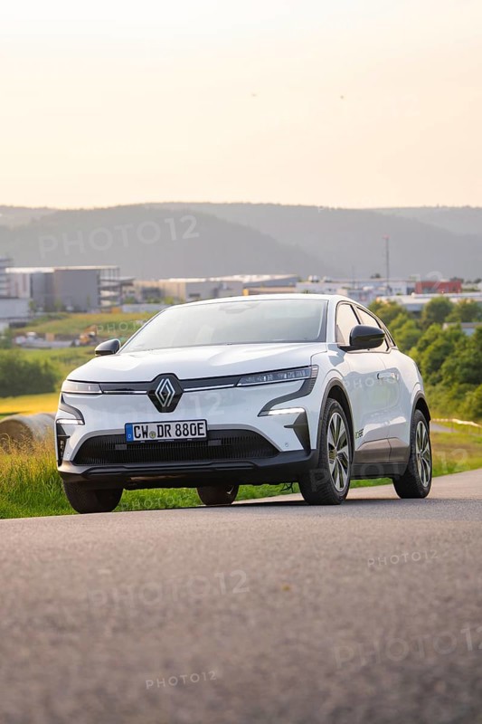 Car driving along a road with a view of modern buildings in the background, Renault Megane, Deer E- Carsharing, electric car, Gechingen, Germany