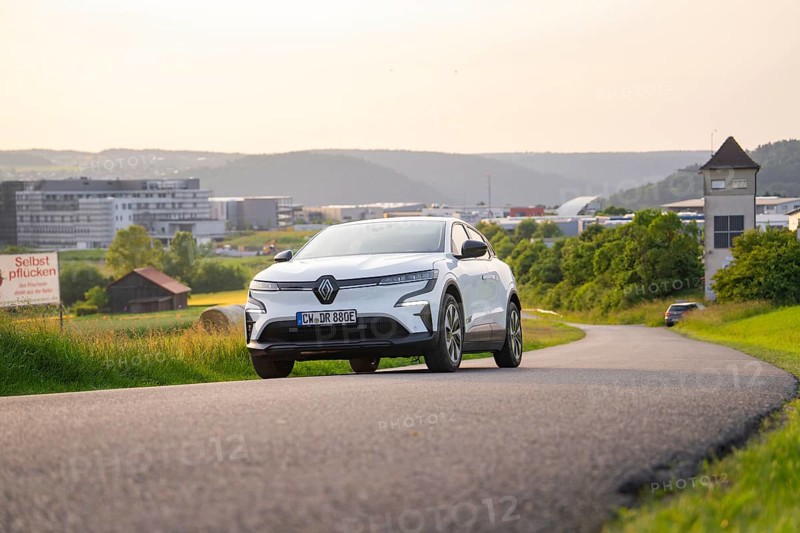Car driving on a curvy road with modern city view in the background, Renault Megane, Deer E- Carsharing, electric car, Gechingen, Germany