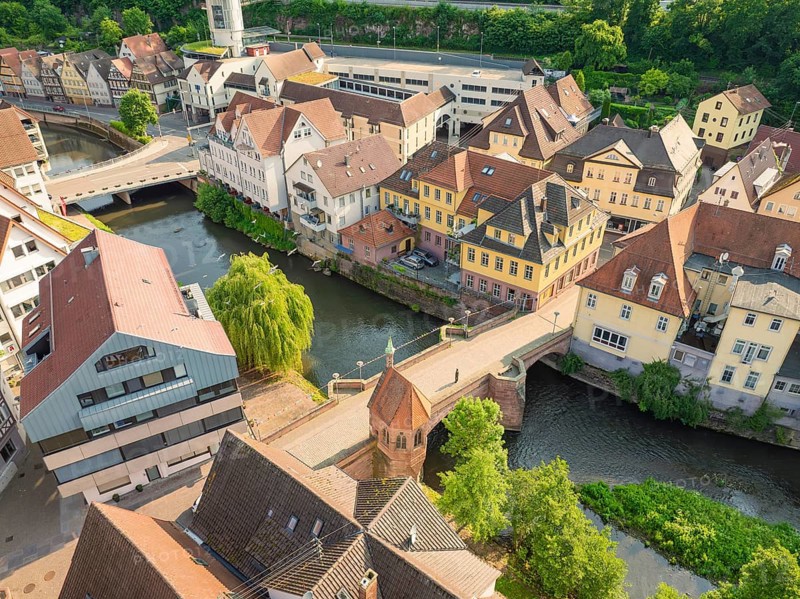 Aerial view of a town with river and many half-timbered houses in sunlight, Calw, Black Forest, Germany