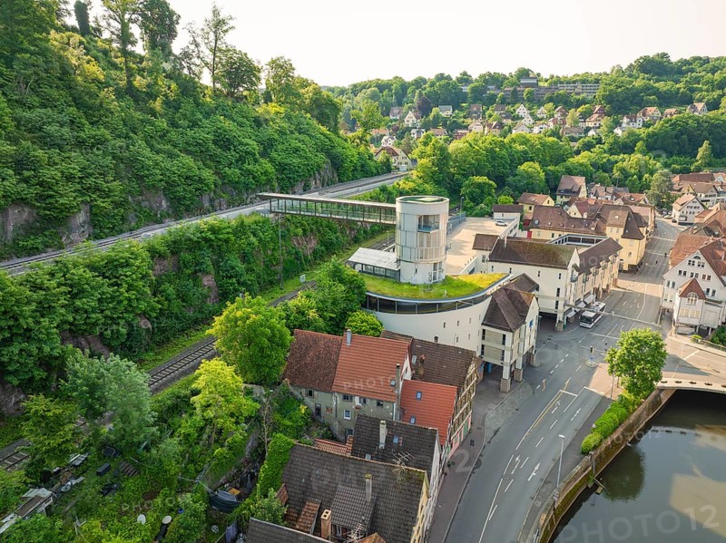 Modern building with a view of an idyllic old town and green hills, Calw, Black Forest, Germany