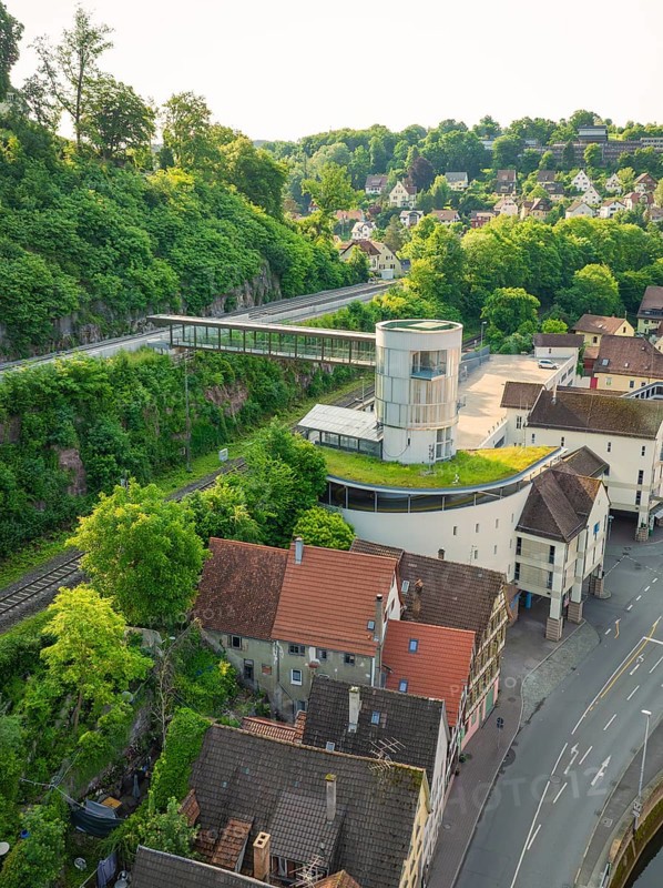 A modern structure with a green roof above a historic urban landscape, Calw, Black Forest, Germany