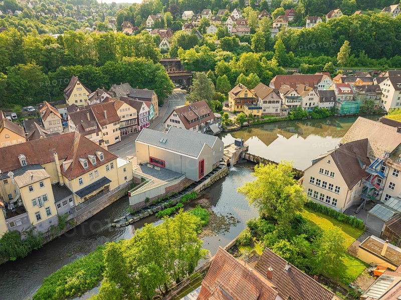 Idyllic town with river in front of a wooded hill with half-timbered architecture, Calw, Black Forest, Germany